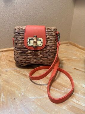 Woven Straw Crossbody with Coral Accent and Turn-Lock Closure